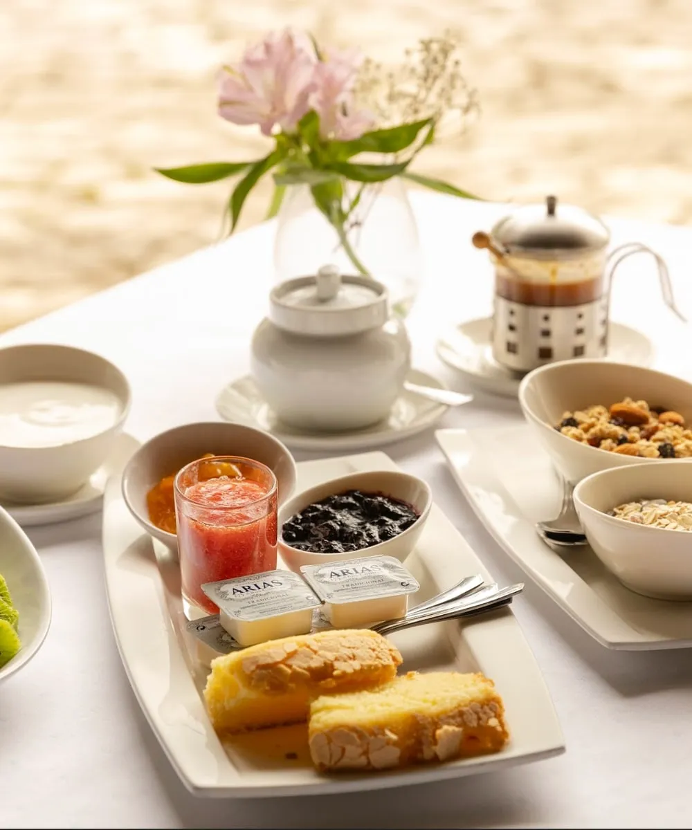 Breakfast laid out on a table at Amalurra — fresh fruit, bread, eggs, and condiments arranged for the morning meal.
