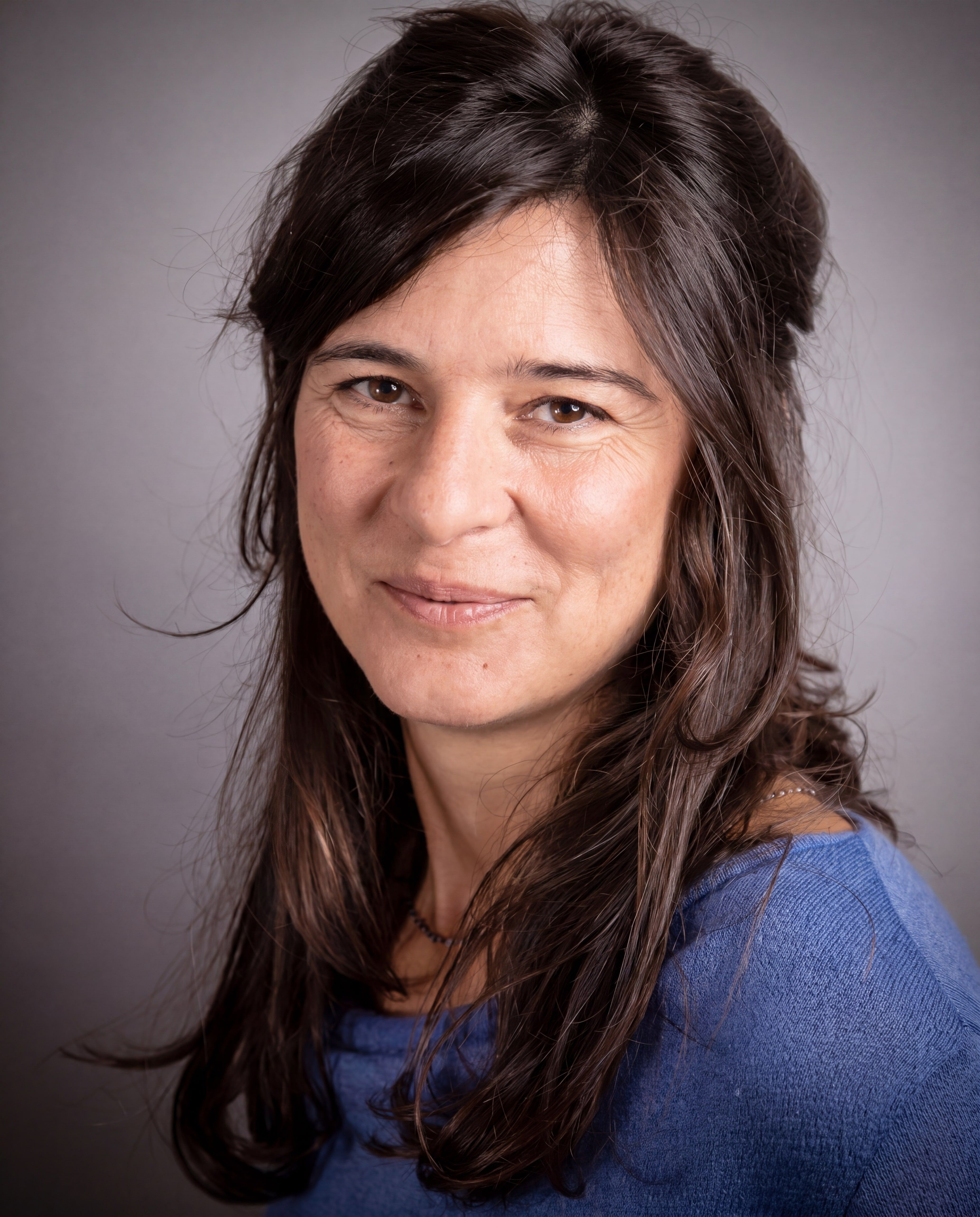 Portrait of Anu Soell — workshop leader, looking off-camera against a soft background.