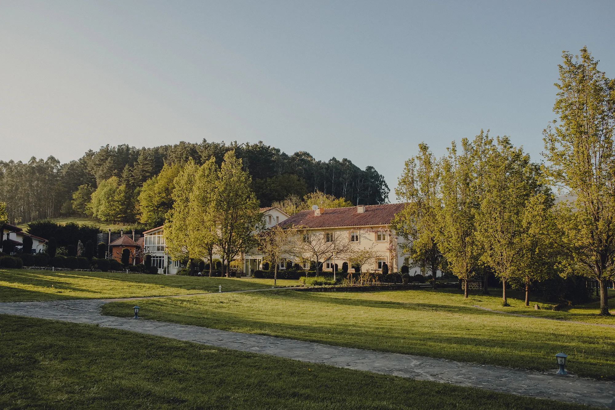 Wide panoramic view of Amalurra EcoHotel set against the Basque mountain valley.