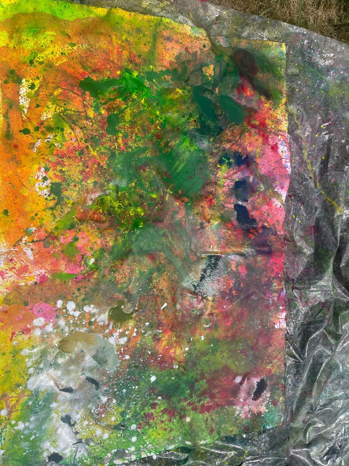 A painting in motion — yellow, red, and dark splatters across a white ground.